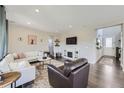 Open living room with a fireplace and large windows at 138 Starlight Cir, Erie, CO 80516