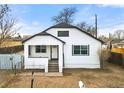 Front view of charming updated home with white exterior at 5401 N Pecos St, Denver, CO 80221