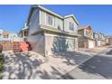 Two-story townhome with attached garage and small deck at 10475 W 82Nd Pl, Arvada, CO 80005