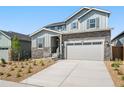 Two-story house with gray siding, stone accents, and a two-car garage at 1787 Water Birch Way, Castle Rock, CO 80108