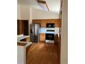 Bright kitchen with stainless steel appliances and hardwood floors at 15935 E 7Th Ave, Aurora, CO 80011