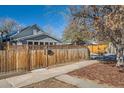 Updated craftsman home with a fenced yard and wood fence at 845 Mariposa St, Denver, CO 80204