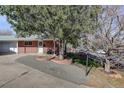 Brick ranch home with a landscaped front yard and paved walkway at 6193 S Prescott St, Littleton, CO 80120