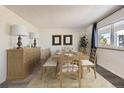 Bright dining room featuring a wood table and chairs, and a large window at 4940 E Donald Ave # 8, Denver, CO 80222