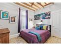 Bright bedroom with hardwood floors, featuring a comfy bed and unique wall art at 3139 Umatilla St, Denver, CO 80211