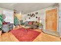 Living room with grey couches, coffee table, and wood floors at 1172 S Eagle Cir # B, Aurora, CO 80012