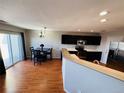 Eat-in kitchen with dark cabinetry and island at 5307 S Picadilly Way, Aurora, CO 80015
