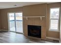 Living room featuring a fireplace and sliding glass door to a deck at 1333 S Cathay Ct # 101, Aurora, CO 80017