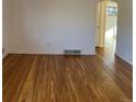 Living room with hardwood floors and an arched doorway at 2548 S Tennyson Way, Denver, CO 80219