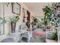 Front porch with wicker furniture and plants at 1521 Pontiac St, Denver, CO 80220