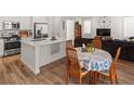 Modern kitchen with island, stainless steel appliances, and hardwood floors at 17785 Fox St, Broomfield, CO 80023