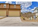 Attached garage with driveway and landscaping at 3406 Emily St, Castle Rock, CO 80109