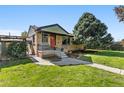 Charming Ranch home with a well-maintained lawn and inviting front porch at 2348 W Ford Pl, Denver, CO 80223