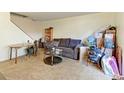 Spacious living room with couch, coffee table, and shelving at 8047 Wolff St # F, Westminster, CO 80031