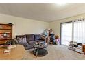 Cozy living room features a comfy couch and access to a patio at 8047 Wolff St # F, Westminster, CO 80031