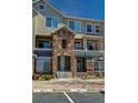 Three-story townhome building with stone accents at 479 Black Feather Loop # 319, Castle Rock, CO 80104