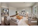 Virtually staged living room featuring hardwood floors and neutral decor at 8311 Ogden St, Denver, CO 80229
