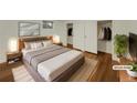 Virtually staged main bedroom with hardwood floors and walk-in closet at 8311 Ogden St, Denver, CO 80229