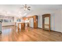 Kitchen features hardwood floors and an island at 11856 W Maplewood Ave, Littleton, CO 80127