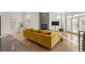 Spacious living area with a mustard yellow couch and a modern fireplace at 175 Harrison St, Denver, CO 80206