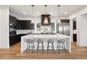Modern kitchen with white island and dark cabinets at 2504 Zenobia St, Denver, CO 80212