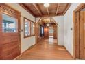 Wooden floors, walls, and door create a warm welcome in this cabin's entryway at 30232 Hilltop Dr, Evergreen, CO 80439