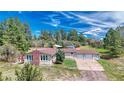 Aerial view of a ranch home with a large yard and mountain views at 456 Verdos Dr, Elizabeth, CO 80107