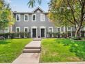 Gray two-story duplex with a well-maintained lawn and walkway at 232 W 5Th Ave, Denver, CO 80204