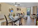 Living room with dining area, hardwood floor, and patio access at 2281 S Vaughn Way # 111A, Aurora, CO 80014