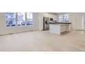 Modern kitchen with white cabinets, stainless steel appliances, and an island at 14554 W 91St Dr # A, Arvada, CO 80005