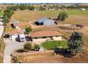 Aerial view of a ranch house on a large lot with outbuildings at 1637 S Us Highway 287, Berthoud, CO 80513