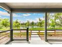 Covered patio overlooks a serene lake with walking paths at 3450 W 62Nd Pl, Denver, CO 80221