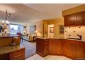 Open concept kitchen with breakfast bar, living area view, and modern finishes at 1625 Larimer St # 904, Denver, CO 80202