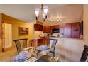 Bright dining area with a glass table and four chairs, adjacent to the kitchen at 1625 Larimer St # 904, Denver, CO 80202