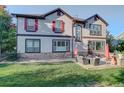 Large backyard with patio, seating area, and mature trees at 5033 Silver Feather Way, Broomfield, CO 80023
