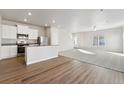 Modern kitchen with stainless steel appliances and island at 2971 Pershing St, Strasburg, CO 80136