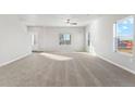 Bright and spacious living room with carpeted floors at 2971 Pershing St, Strasburg, CO 80136