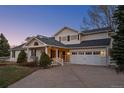 Front view of a charming two-story house with white exterior at 9362 Tollgate Dr, Longmont, CO 80503