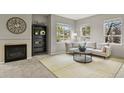 Cozy living room featuring a fireplace and large windows at 16 Whitehaven Cir, Highlands Ranch, CO 80129