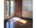 Front entry with hardwood floors and a door to the outside at 9105 E Lehigh Ave # 63, Denver, CO 80237