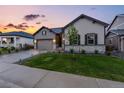 Two-story house with attached garage and landscaped yard at 6940 Petunia Pl, Castle Rock, CO 80108