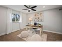 Home office with hardwood floors and large artwork at 6690 S Sheridan Blvd, Littleton, CO 80123
