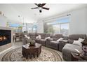 Spacious living room featuring a cozy fireplace and sectional sofa at 8547 Gold Peak Dr # G, Highlands Ranch, CO 80130