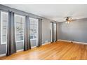 Living room with hardwood floors and large windows at 1626 S Sheridan Blvd, Denver, CO 80232