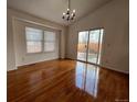 Sunlit dining area with hardwood floors and sliding glass doors to patio at 20148 E Dartmouth Dr, Aurora, CO 80013