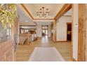 Bright and spacious entryway with hardwood floors and elegant chandelier at 5230 Bow Mar Dr, Littleton, CO 80123