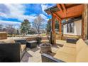 Relaxing patio area with comfortable seating and a fire pit at 5230 Bow Mar Dr, Littleton, CO 80123