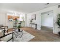 Open concept living room with kitchen and dining area at 8813 Colorado Blvd # 207, Thornton, CO 80229