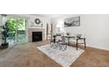 Living room featuring a fireplace and access to a private balcony at 8813 Colorado Blvd # 207, Thornton, CO 80229