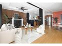 Open living room with exposed brick fireplace and modern decor at 1473 Yates St, Denver, CO 80204